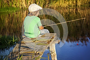 Happy boy go fishing on the river, one children fisherman with a