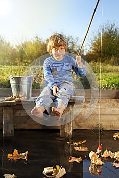 Happy boy go fishing on the river, one children fisherman with a