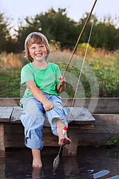Happy boy go fishing on the river with pet, one children and kit