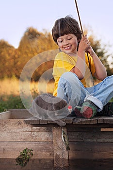 Happy boy go fishing on the river with pet, one children and kit
