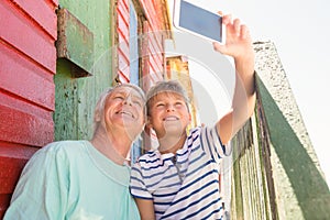 Happy boy with grandfather taking selfie