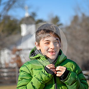 Happy Boy With Green Coat by Church