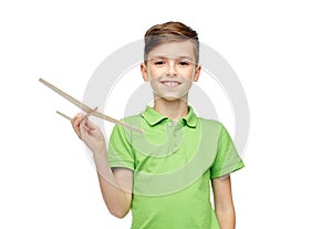 Happy boy in green polo t-shirt with toy airplane