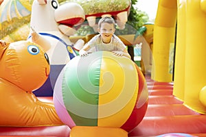 Happy boy having a lots of fun on a colorful inflate castle. Colorful playground. Activity and play center for kids