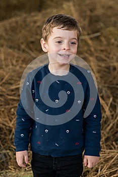Happy boy in  haystack portrait