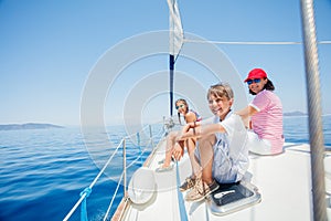 Happy boy with his mother and sister resting on yacht