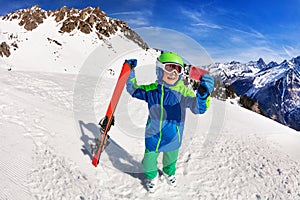 Happy boy hold ski taking picture with smartphone