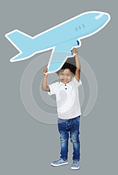 Happy boy holding an airplane icon