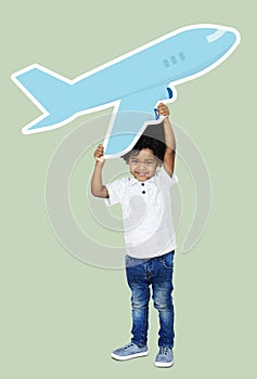 Happy boy holding an airplane icon