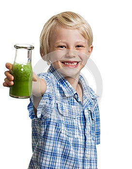 Happy boy holding bottle of green smoothie