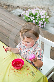 Happy Boy Holding a Pink Dyed Easter Egg