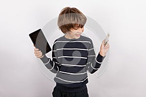 Happy boy holding a tablet pc device and a bank card