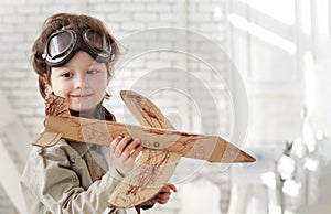 Happy boy with jet airplane in hand