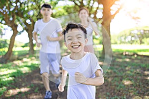 Happy boy  Jogging with parents in the city park