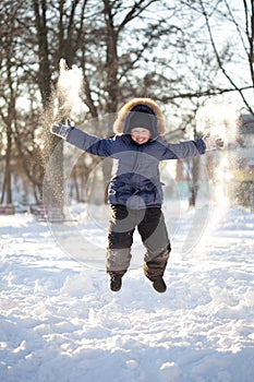 Happy boy jump outdoors