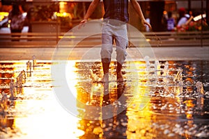 Happy boy jump on water Philadelphia city fountain