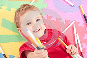 Happy boy with kids drawing pens photo