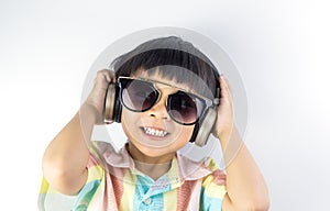 Happy boy is listening to music on headphone isolated