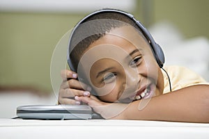 Happy Boy Listening To Portable CD Player