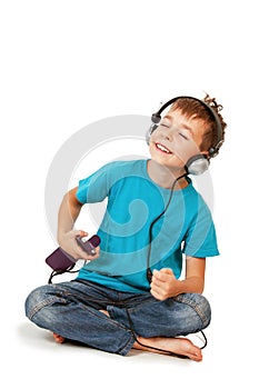 Happy boy listens music with smartphone