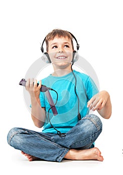 Happy boy listens music with smartphone