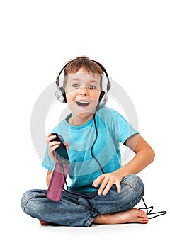 Happy boy listens music with smartphone