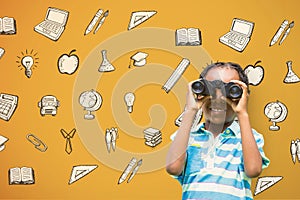 Happy boy looking through binoculars against yellow background with graphics