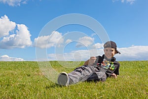 Happy boy lying on the meadow