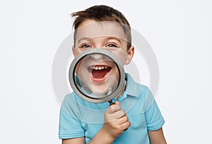 Happy boy with magnifying glass