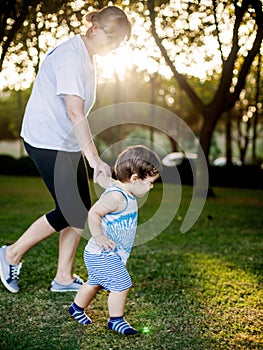 Happy boy making funny faces and expressions while walking with his grandmother