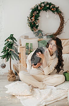 Happy boy with mather near Christmas tree