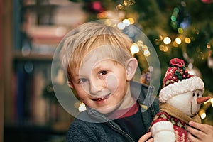 Happy boy near Christmas tree