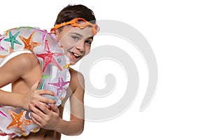 Happy boy with orange swimming goggles and inflatable circle, concept of vacation and rest, on a white background