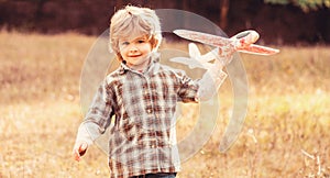 Happy boy play airplane. Little boy with plane. Little kid dreams of being a pilot