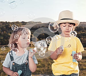 Happy Boy play in bubbles in field sunny summer day