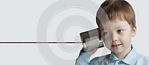 Happy boy play in the tin can phone