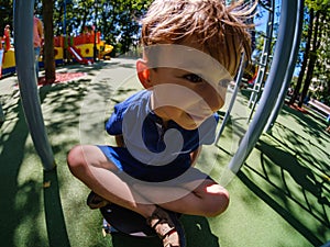 Happy boy on playground, summer childhood in park,  child leisure