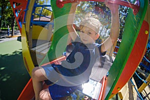 Happy boy on playground, summer childhood in park,  fun little