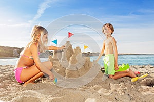 Happy boy playing beach games with his sister