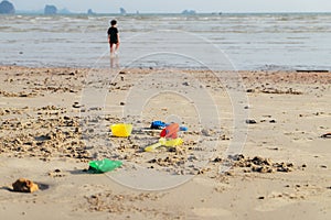 Happy boy playing beach toy and splashing in the sea beach