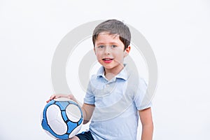 Happy boy playing football. Cute child, young male teen goalkeeper enjoying sport game. Little footballer holding ball, isolated