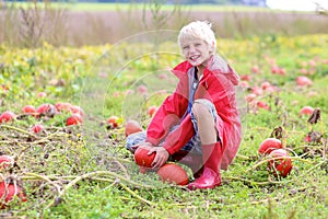 Happy boy playing on pumpkin field