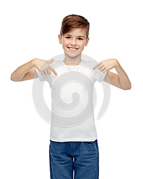 Happy boy pointing finger to his white t-shirt