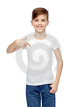 Happy boy pointing finger to his white t-shirt
