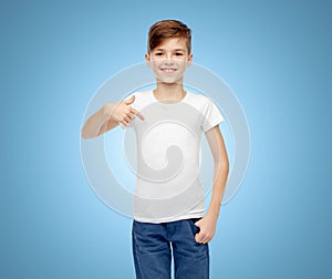 Happy boy pointing finger to his white t-shirt