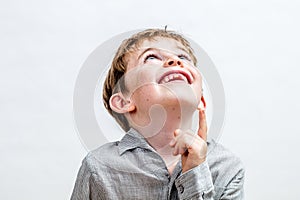 Happy boy pointing his finger up for concept of curiosity