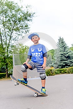 Happy boy practicing balancing on a skateboard