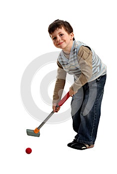 Happy boy preparing to hit a golf ball