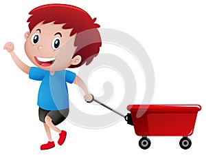 Happy boy pulling red wagon