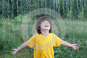 Happy boy in rain summer